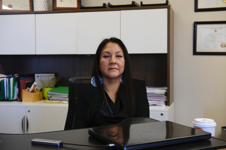 Eleanore Sunchild is sitting at a desk with only the top portion of her body visible