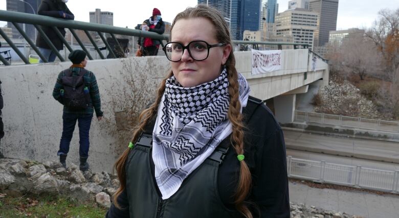 A woman is pictured looking towards the camera.