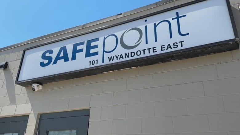 A building sits in front of a traffic crossing, with a sign that reads SafePoint.