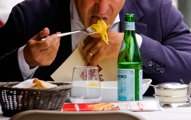 A man is seen eating pasta at a restaurant in Milan, in a file photo taken in June 2023.