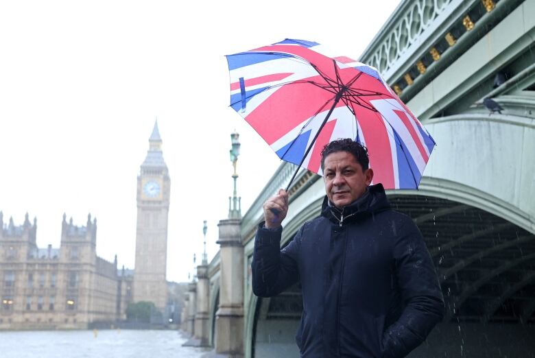 Francesco Mazzei, an Italian chef and restaurant owner, poses for a photo near London's parliamentary buildings.