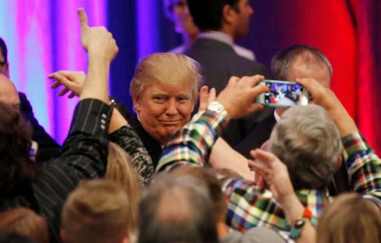 Trump surrounded by happy supporters