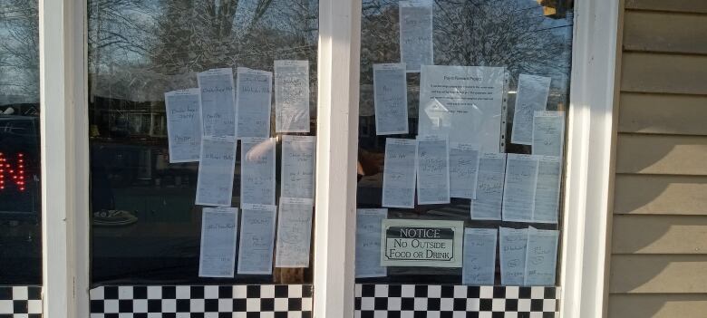 Meal receipts are shown in a restaurant window