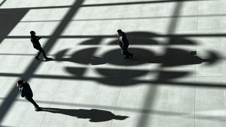 Pedestrians cross the foyer of the Radio-Canada headquarters in Montreal on Oct. 31, 2023.