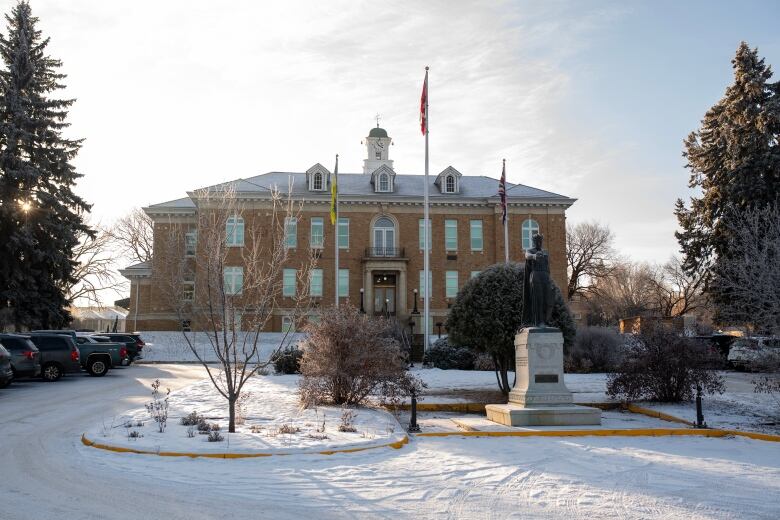 The front area of a courthouse in Prince Albert, Sask., coated in snow amid a sunny morning.