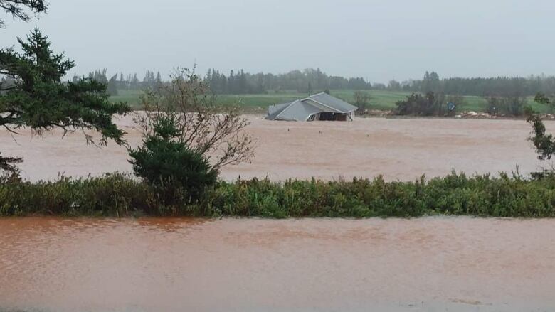 A house is floating in red soil filled water 