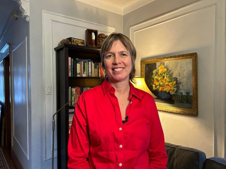 A woman stands in a room.