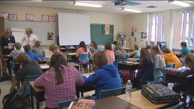 PEI Classroom, students sit at desks. 