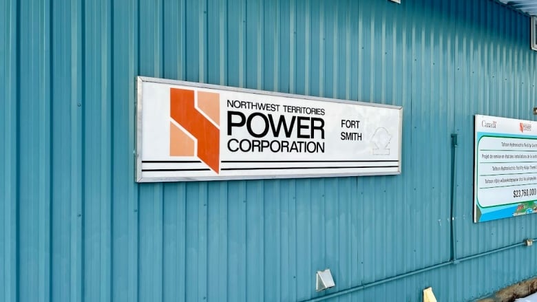 A photo of a Northwest Territories Power Corporation sign on a blue building.