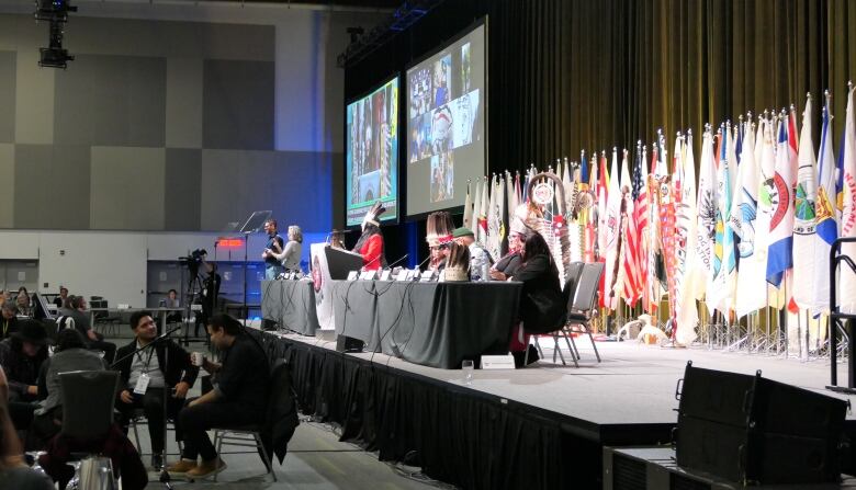 Political leaders seated on a stage.