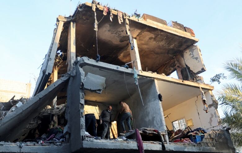 Men inspect damages to homes in Rafah, in the southern Gaza Strip, following Israeli airsrtikes.