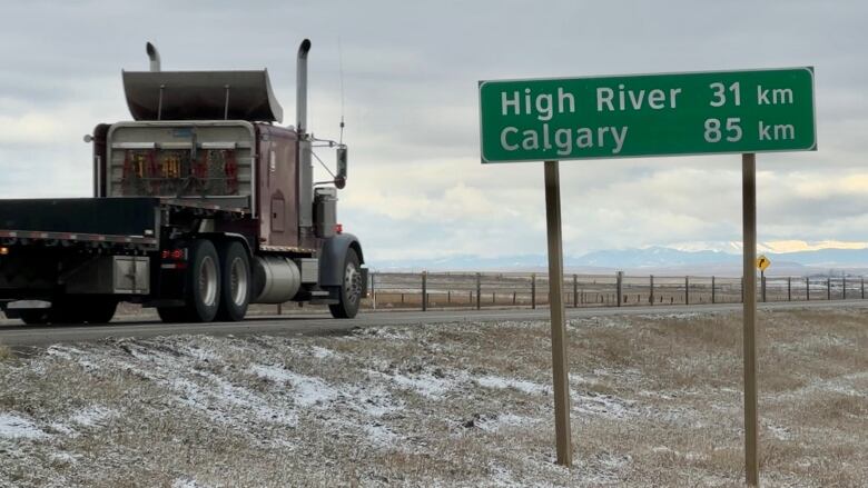 A green sign for High River stands on Highway 2 just outside Nanton.