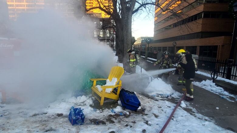 Firefighters extinguish a burning tent.