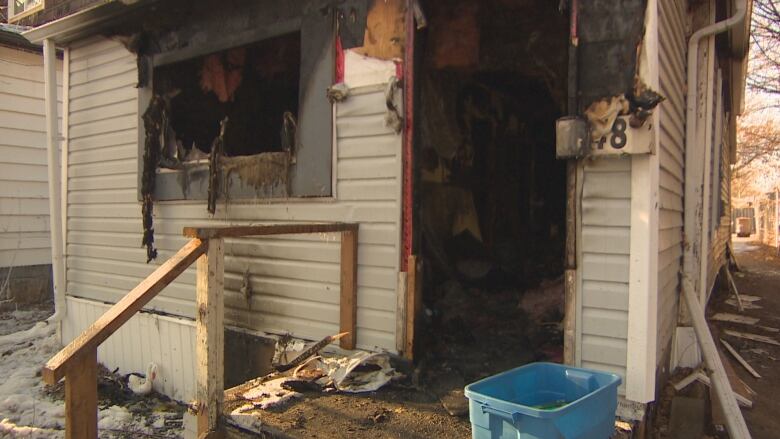 The partially melted exterior and charred inside of a home can be seen