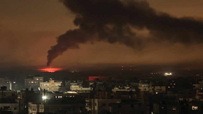 A picture taken from Rafah shows smoke billowing following Israeli bombardment of Khan Yunis in the southern Gaza Strip.