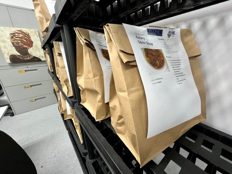 Several paper bags ae lined up, with a recipe for gravy stew/coup stapled to them.