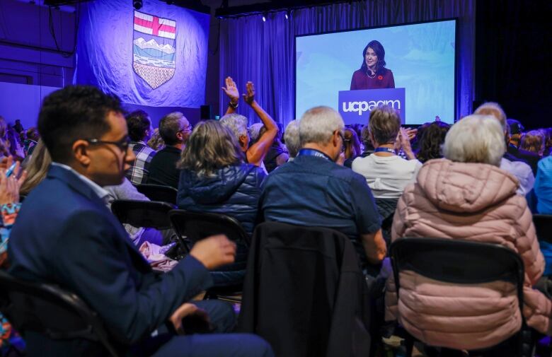 UCP members applaud and listen to leader Danielle Smith at the 2023 party convention.