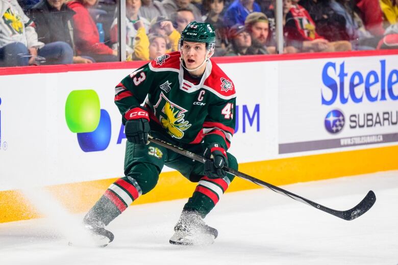 A man in a Halifax Mooseheads uniform on the ice during a hockey game.