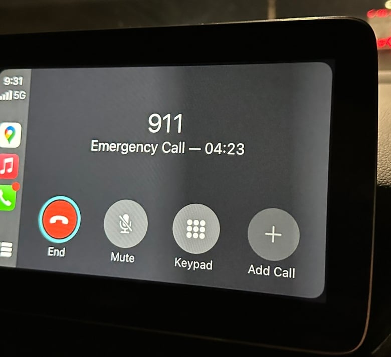 Screen of smart monitor in a car showing the length of a call with 911 as four minutes and 23 seconds.