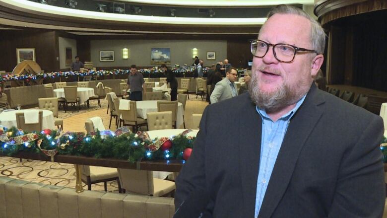 a man with glasses and a beard wearing a suit