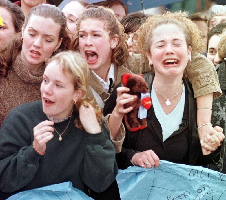 A group of teenage girls screaming.