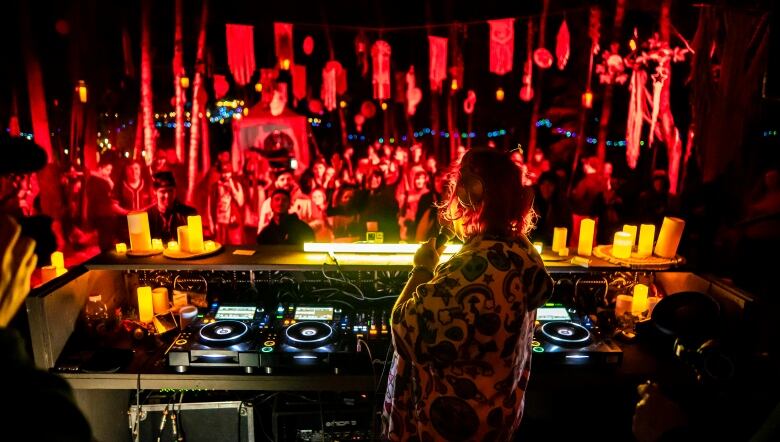 Female DJ performs her DJ set to a crowd