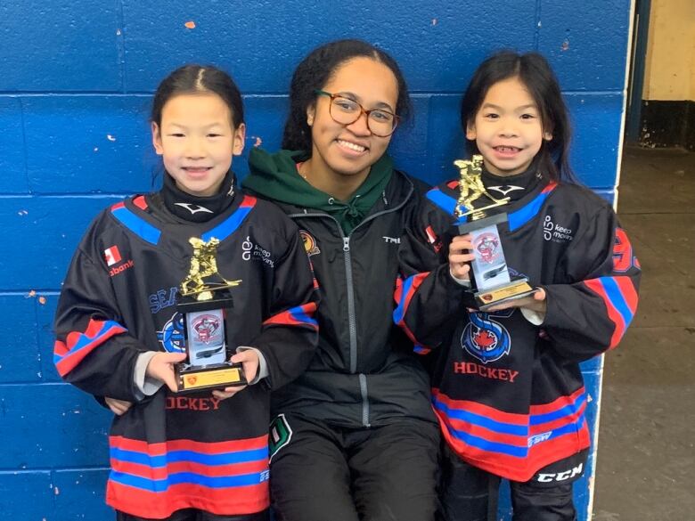 Nayla Brooks is pictured with two young athletes.