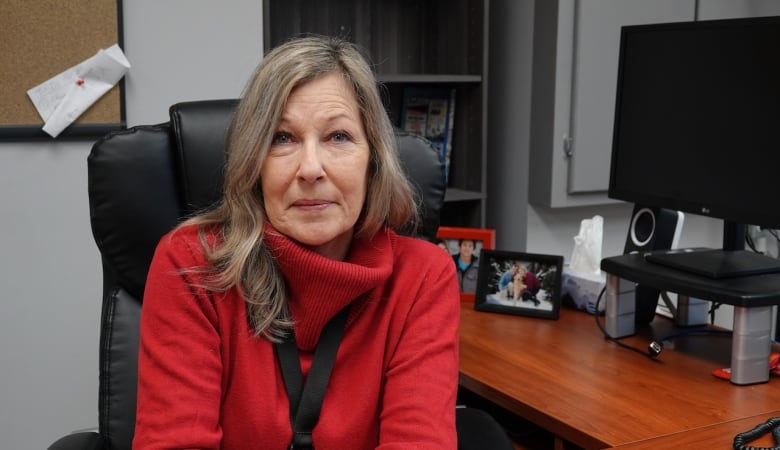 Lisa McGee sits at her office desk