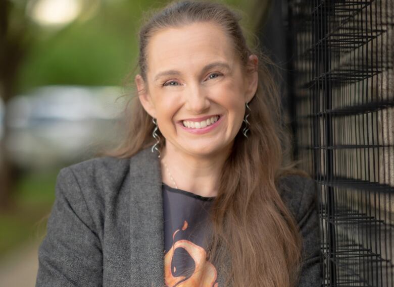 A woman smiles in a professional headshot. 