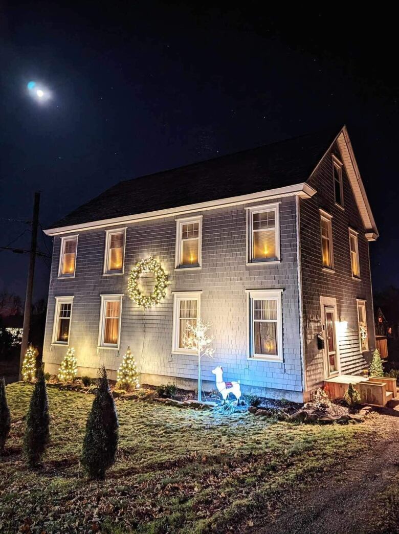 The windows glow in a home decorated for Christmas. 