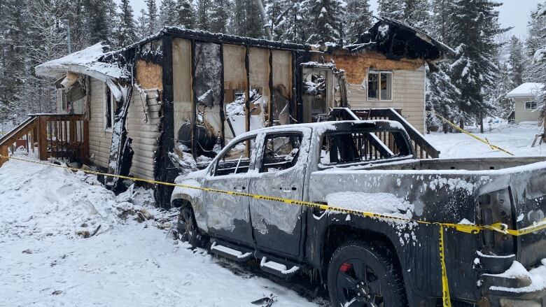 The remains of a burnt home, and truck.