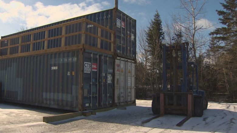 Three stacked shipping containers.