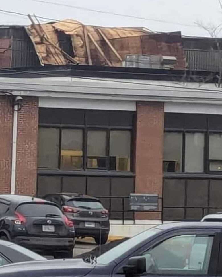 A large portion of roof from a vacant building on George Street detached in high winds and landed on the roof of the salon next door.