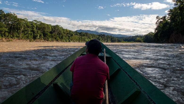 A man sits in a boat.