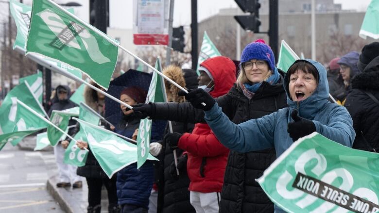 Striking health-care workers picket in front of the McGill University Health Centre. 