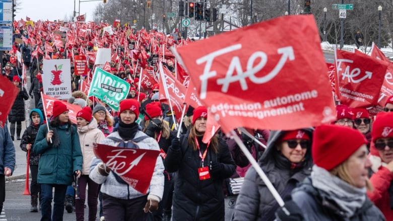 Striking teachers holding red FAE union flags