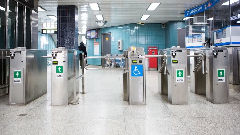 The gates to enter a subway station, including a wheel-chair accessible gate.