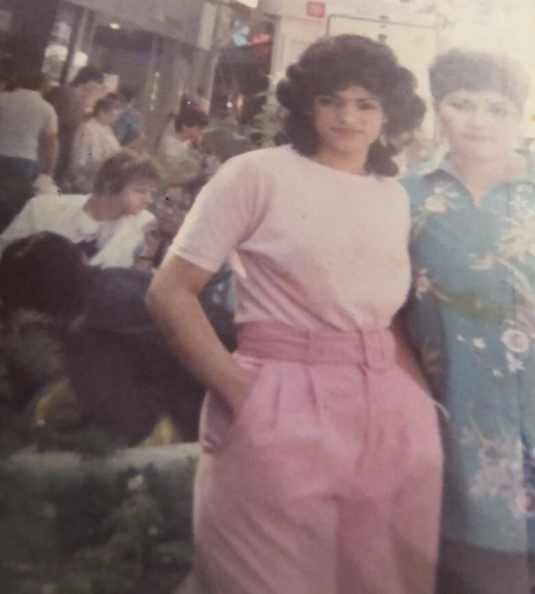 A picture of an old photograph of a woman dressed entirely in pink. 