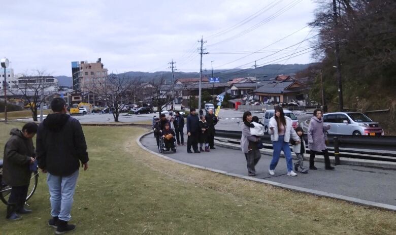 People evacuate toward higher ground after a tsunami warning in Japan.