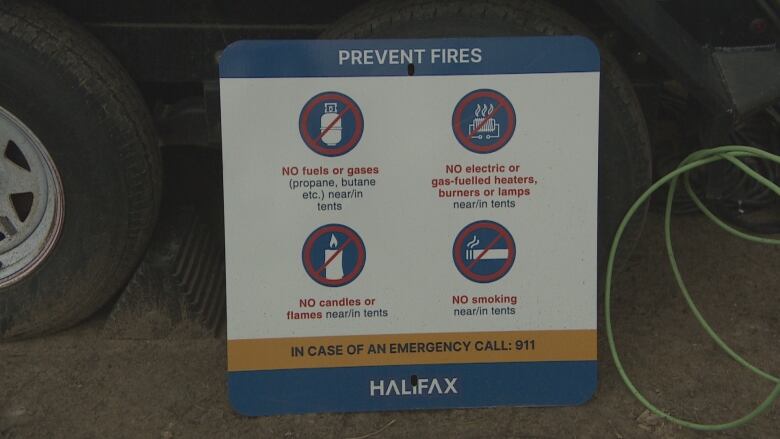 A sign from the city of Halifax reads that there should be no fuels or gasses, open flames, heaters or smoking in or near tents.