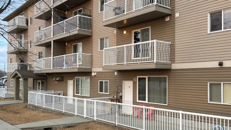 An apartment building is seen on a sunny day.