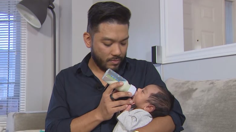 Joey Salmingo is pictured feeding his son.