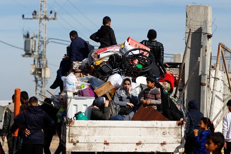 People ride in a truck in Gaza.