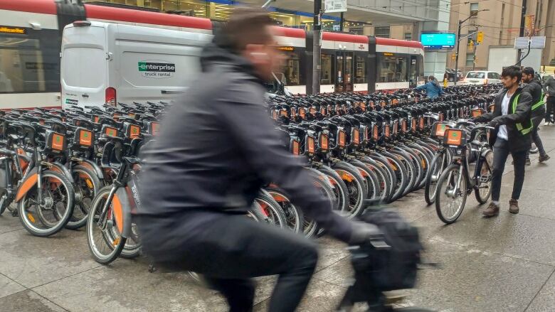 Bike Share Toronto workers collect and arrange bicycles at the corner of KIng St and Bay St. Bike Share Toronto offers more than 9 000 bikes at over 700 stations across Toronto