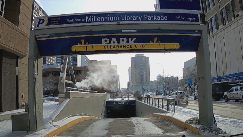 A ramp leads down underground. Above the ramp, a sign reads 