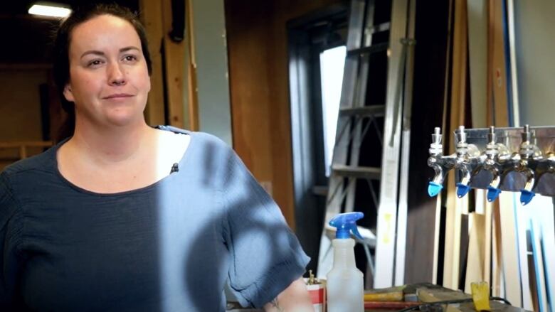 A portrait of a woman in a sunny room. 