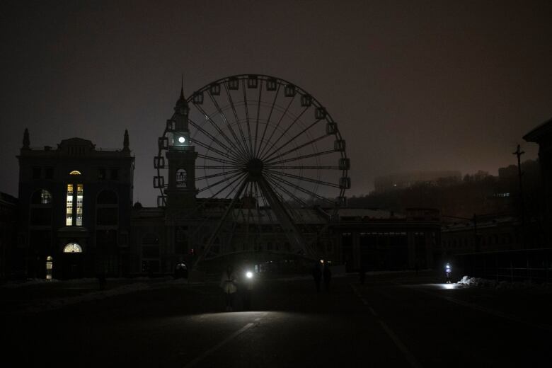 A view of Podil district during a blackout after a Russian rocket attack in Kyiv, Ukraine, Wednesday, Nov. 23, 2022.