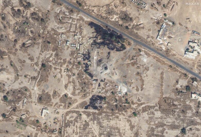 A satellite aerial view shows damaged buildings following an airstrike.