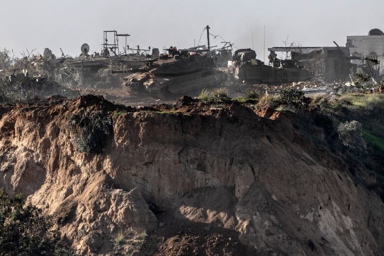 Israeli army vehicles seen moving inside the Gaza Strip, as viewed from a vantage point in southern Israel.