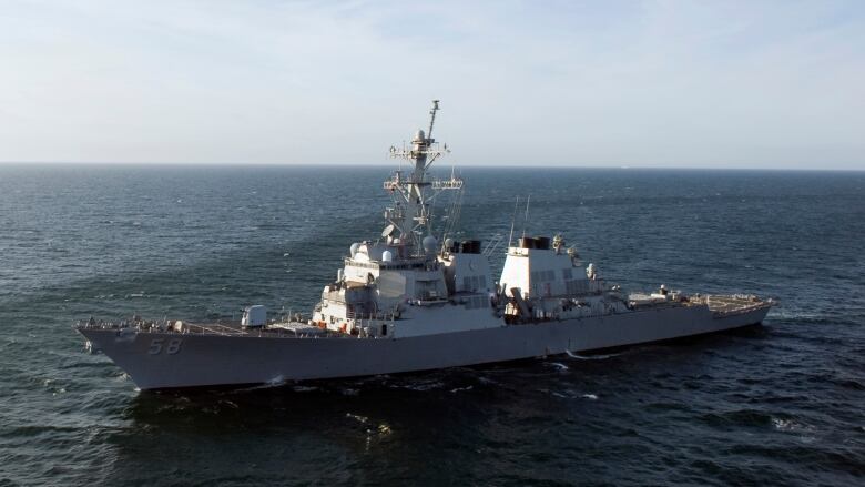 A warship is seen in the ocean.